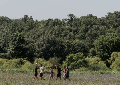 camp counselors walking through a field